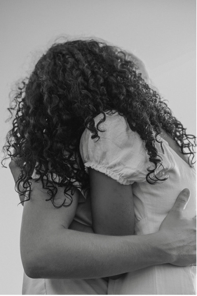 Two people hugging due to stress
