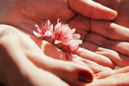 Woman holding flower in her palm