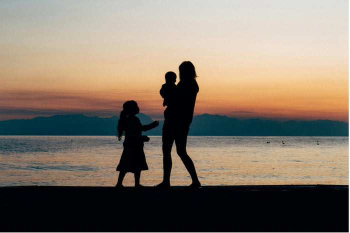 mother with children at sunset image
