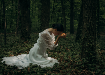 Woman praying in the forest