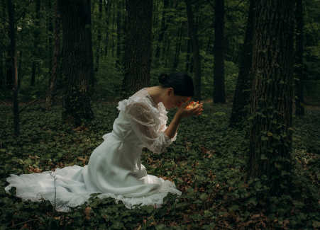 Woman praying in the forest